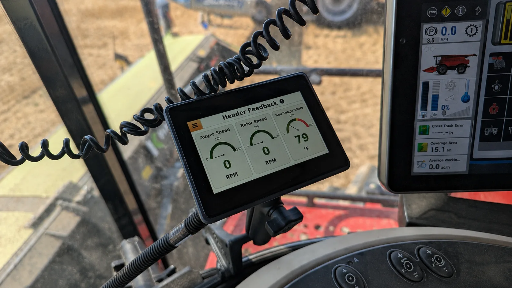 Header Feedback monitor showing auger speed, rotor speed, and belt temperature